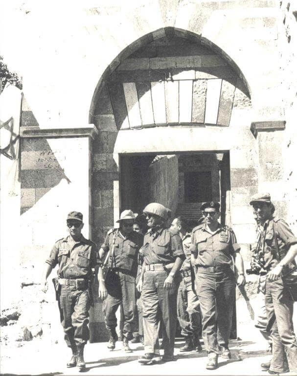 Generals Moshe Dayan and Rechavam Zeevi exiting the Old City .